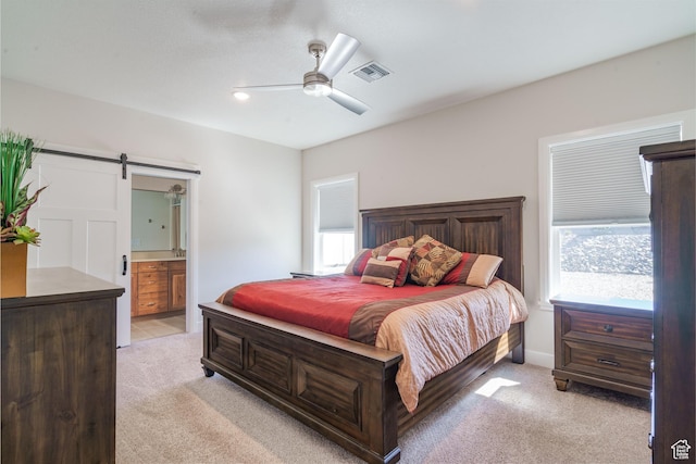 1044 E Southern Homestead Blvd, Enoch, UT 84721 - bedroom with light colored carpet, visible vents, a barn door, a ceiling fan, and ensuite bath