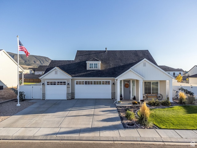 1044 E Southern Homestead Blvd, Enoch, UT 84721 - view of front of house with board and batten siding, fence, stone siding, driveway, and a front lawn