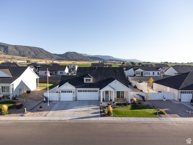 1044 E Southern Homestead Blvd, Enoch, UT 84721 - view of front facade with driveway, a residential view, fence, a mountain view, and a front yard