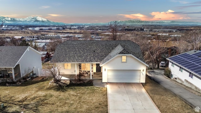 2172 S Dakota Ave, Provo, UT 84606 - view of front of house featuring a garage, a shingled roof, a mountain view, and a lawn
