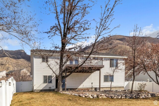 2172 S Dakota Ave, Provo, UT 84606 - rear view of house with a yard, fence, and a mountain view