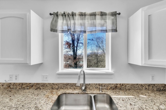 2172 S Dakota Ave, Provo, UT 84606 - room details with white cabinets, a sink, and light stone countertops