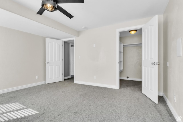 2172 S Dakota Ave, Provo, UT 84606 - unfurnished bedroom with carpet floors, a ceiling fan, baseboards, a closet, and a walk in closet