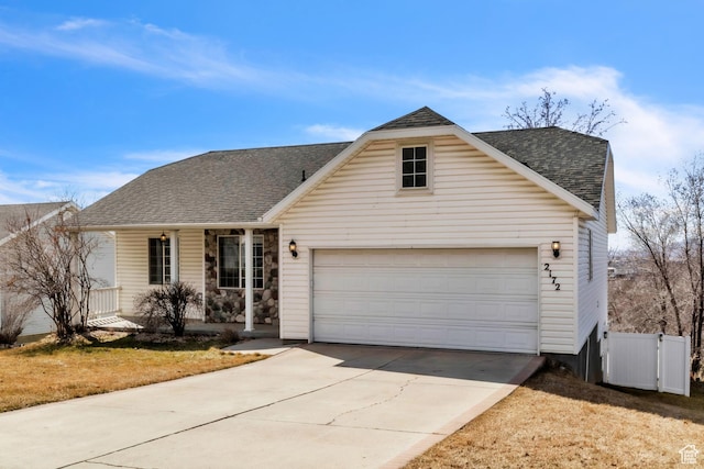 2172 S Dakota Ave, Provo, UT 84606 - traditional-style house featuring roof with shingles, covered porch, concrete driveway, an attached garage, and fence