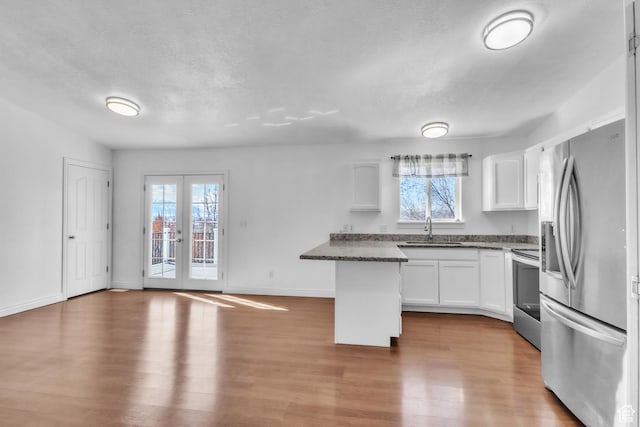 2172 S Dakota Ave, Provo, UT 84606 - kitchen featuring french doors, appliances with stainless steel finishes, a sink, and white cabinets