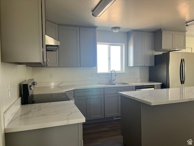 1943 S State St, Roosevelt, UT 84066 - kitchen with light stone counters, a sink, freestanding refrigerator, under cabinet range hood, and electric range