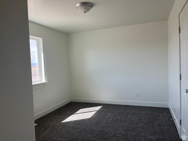 1943 S State St, Roosevelt, UT 84066 - empty room featuring baseboards and dark colored carpet