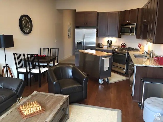 6169 Park Ln Unit 9, Park City, UT 84098 - kitchen featuring stainless steel appliances, a kitchen island, a sink, light wood-style floors, and dark brown cabinets