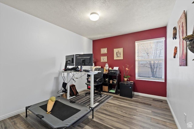 5009 W Greenstreak Dr, Riverton, UT 84096 - home office with a textured ceiling, baseboards, and wood finished floors