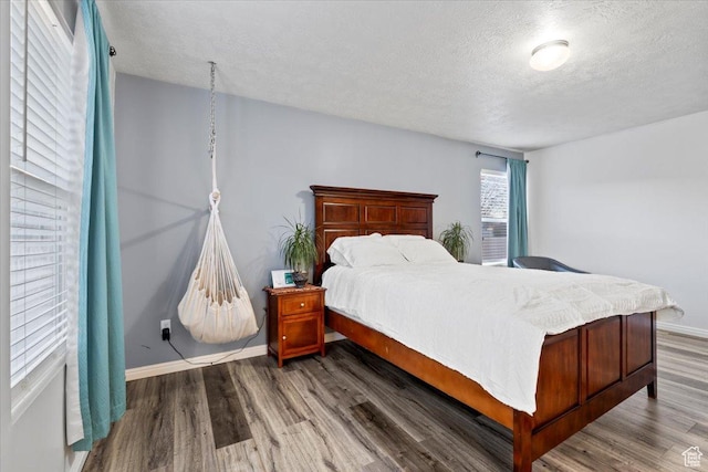 5009 W Greenstreak Dr, Riverton, UT 84096 - bedroom with a textured ceiling, baseboards, and wood finished floors