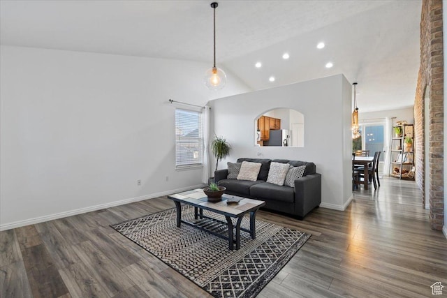 5009 W Greenstreak Dr, Riverton, UT 84096 - living room with lofted ceiling, baseboards, arched walkways, and wood finished floors