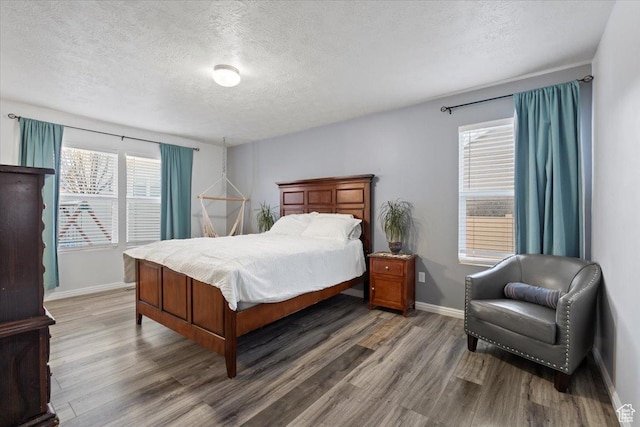5009 W Greenstreak Dr, Riverton, UT 84096 - bedroom featuring a textured ceiling, baseboards, and wood finished floors