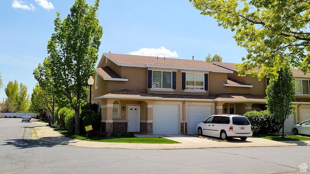 623 W Villa Bluff Dr, Sandy, UT 84070 - view of front of property featuring stone siding, concrete driveway, an attached garage, a shingled roof, and stucco siding