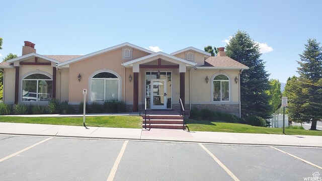 623 W Villa Bluff Dr, Sandy, UT 84070 - view of front of home featuring stucco siding, stone siding, a chimney, and uncovered parking
