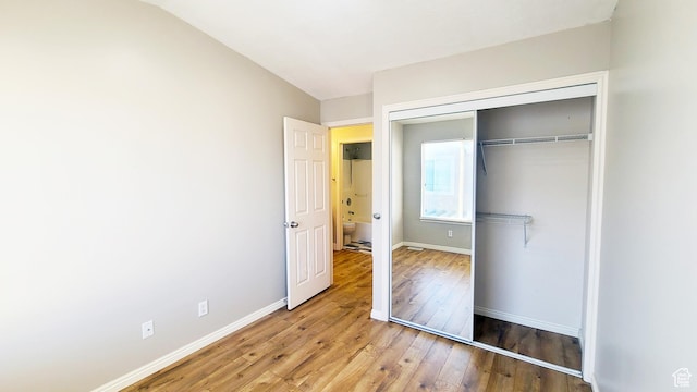 623 W Villa Bluff Dr, Sandy, UT 84070 - unfurnished bedroom featuring hardwood / wood-style floors, a closet, and baseboards
