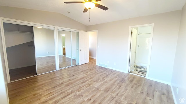 623 W Villa Bluff Dr, Sandy, UT 84070 - unfurnished bedroom featuring two closets, vaulted ceiling, visible vents, and light wood-style flooring