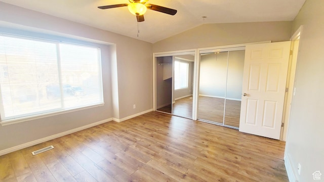 623 W Villa Bluff Dr, Sandy, UT 84070 - unfurnished bedroom with lofted ceiling, wood finished floors, visible vents, baseboards, and two closets
