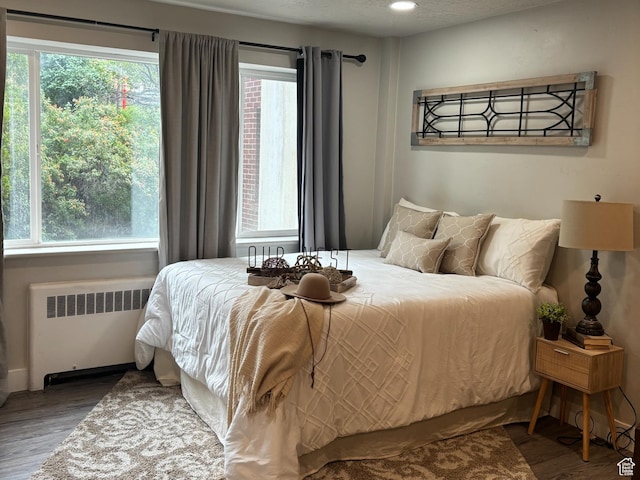 130 S 1300 E Unit 314, Salt Lake City, UT 84102 - bedroom featuring radiator heating unit, wood finished floors, and recessed lighting