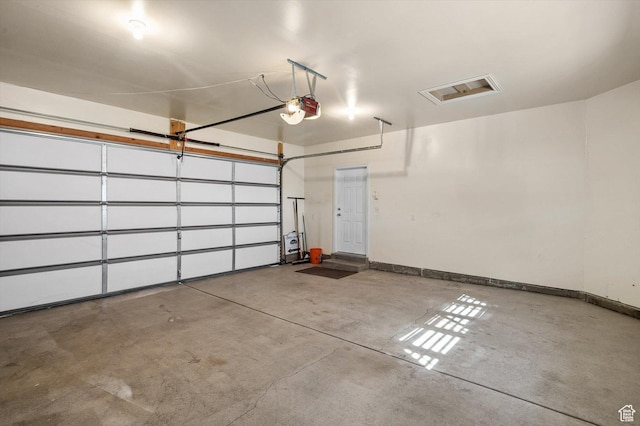 6802 S Triumph Ln, West Jordan, UT 84084 - garage with a garage door opener, visible vents, and baseboards