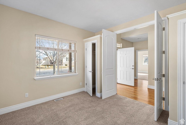 6802 S Triumph Ln, West Jordan, UT 84084 - unfurnished bedroom featuring visible vents, baseboards, and light colored carpet