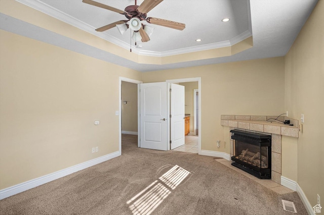 6802 S Triumph Ln, West Jordan, UT 84084 - unfurnished living room with crown molding, a tray ceiling, light colored carpet, and a fireplace
