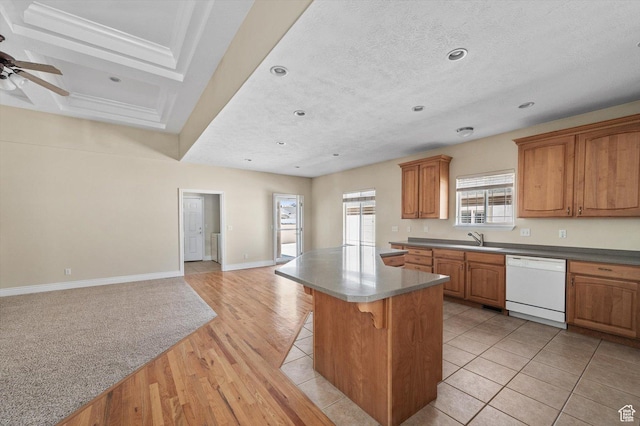 6802 S Triumph Ln, West Jordan, UT 84084 - kitchen with a kitchen island, a breakfast bar, brown cabinets, open floor plan, and white dishwasher