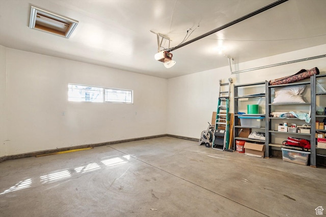 6802 S Triumph Ln, West Jordan, UT 84084 - garage featuring a garage door opener and baseboards