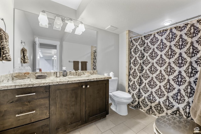 full bathroom featuring a shower with shower curtain, vanity, toilet, and tile patterned floors