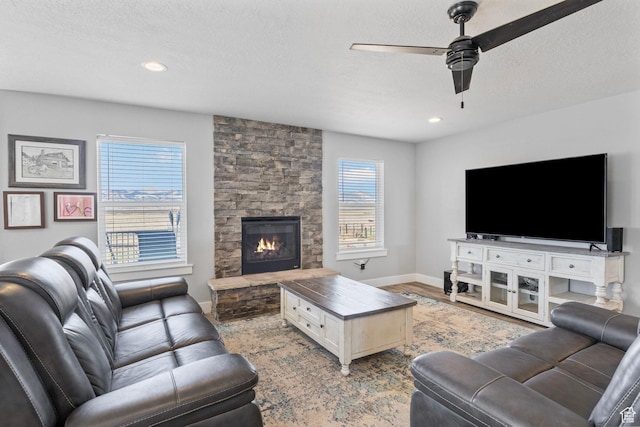180 S Main St, Fayette, UT 84630 - living area with baseboards, a ceiling fan, wood finished floors, a textured ceiling, and a fireplace