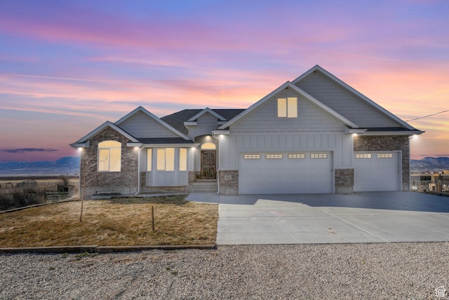 180 S Main St, Fayette, UT 84630 - view of front of home with concrete driveway, stone siding, board and batten siding, and an attached garage