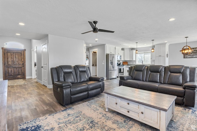 180 S Main St, Fayette, UT 84630 - living room with recessed lighting, a textured ceiling, baseboards, and wood finished floors