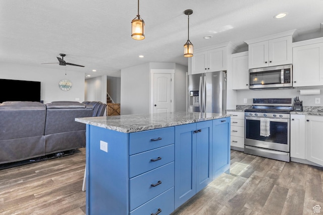 180 S Main St, Fayette, UT 84630 - kitchen with stainless steel appliances, white cabinetry, light wood-style flooring, and blue cabinets