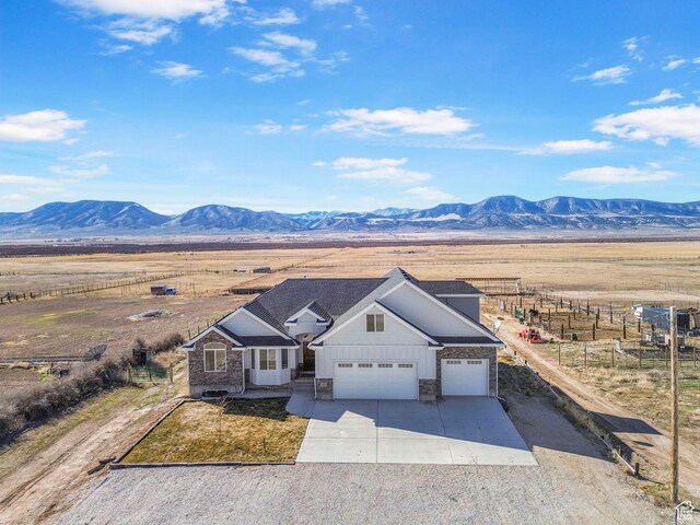 180 S Main St, Fayette, UT 84630 - view of front of house featuring concrete driveway, a rural view, a mountain view, and an attached garage