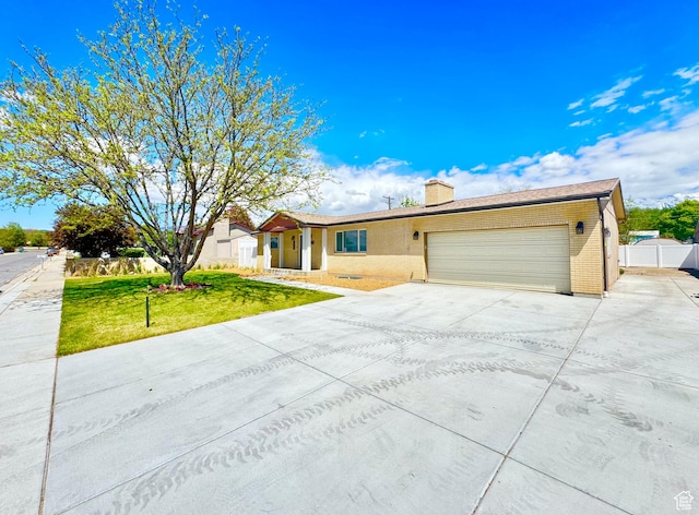770 N 1000 E, Lehi, UT 84043 - ranch-style home featuring brick siding, a garage, a front yard, a chimney, and driveway