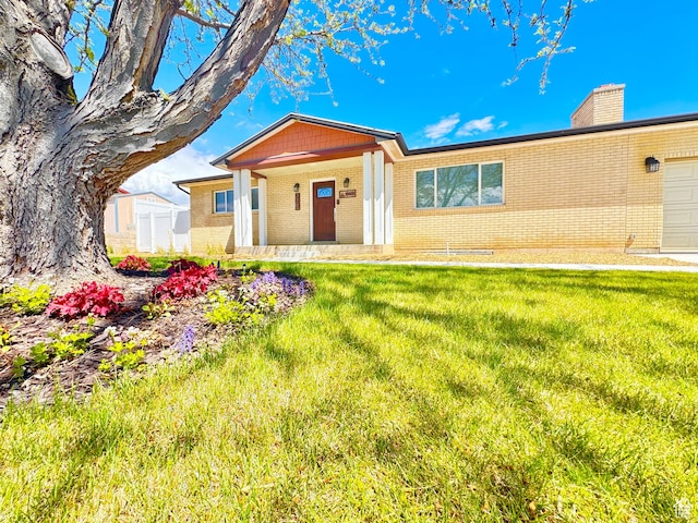 770 N 1000 E, Lehi, UT 84043 - single story home featuring a chimney, a porch, a front lawn, and brick siding