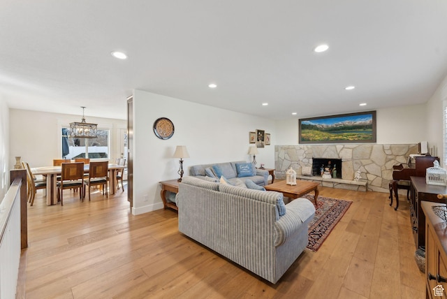 770 N 1000 E, Lehi, UT 84043 - living room featuring a stone fireplace, recessed lighting, light wood finished floors, and a healthy amount of sunlight