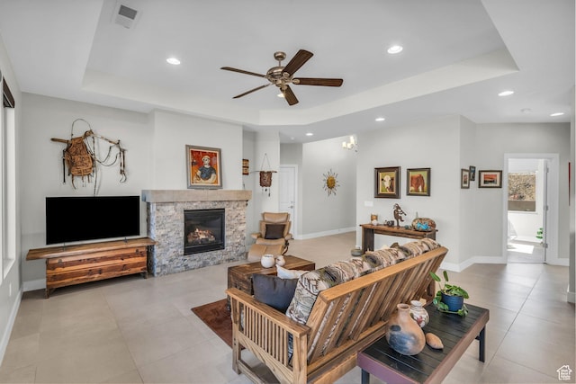 530 W Cougar Way, Ivins, UT 84738 - living area with a ceiling fan, a tray ceiling, baseboards, and a fireplace
