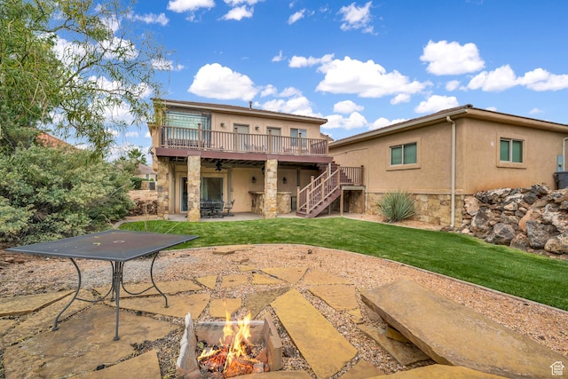806 N 2500 W, Hurricane, UT 84737 - rear view of house featuring stucco siding, a lawn, a patio area, a fire pit, and stairs