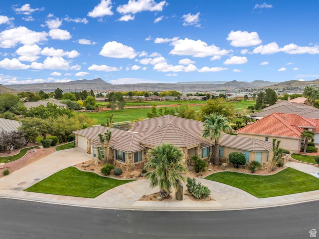 806 N 2500 W, Hurricane, UT 84737 - view of front of home featuring driveway, a front yard, a tile roof, and a mountain view