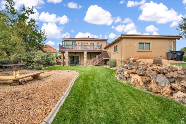 806 N 2500 W, Hurricane, UT 84737 - back of house with a yard, a patio, stucco siding, a wooden deck, and stairs