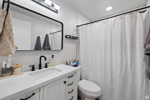 full bath featuring recessed lighting, vanity, and toilet