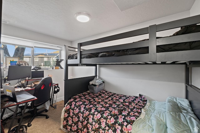 carpeted bedroom featuring visible vents and a textured ceiling