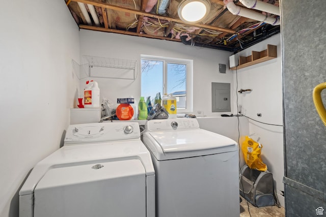 clothes washing area featuring laundry area, washing machine and clothes dryer, and electric panel