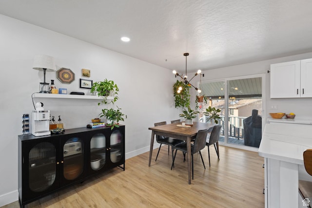 dining area featuring a chandelier, a textured ceiling, recessed lighting, baseboards, and light wood-style floors