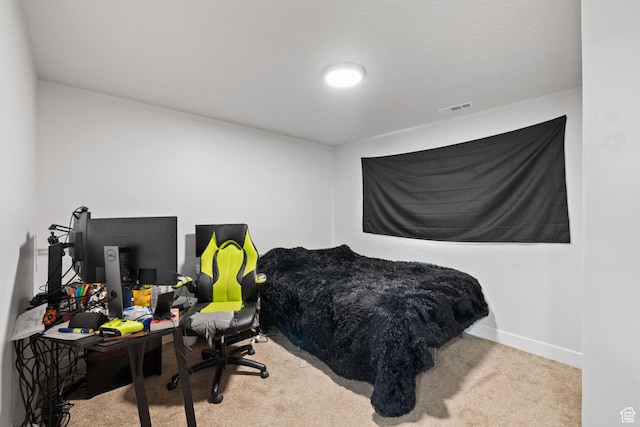 carpeted bedroom with visible vents and baseboards