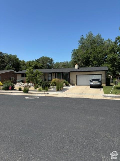 4527 S 2300 W, Roy, UT 84067 - ranch-style home featuring an attached garage, driveway, and a chimney