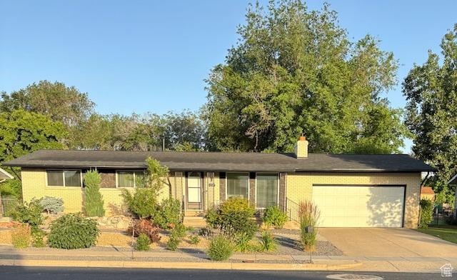4527 S 2300 W, Roy, UT 84067 - single story home with brick siding, an attached garage, and a chimney