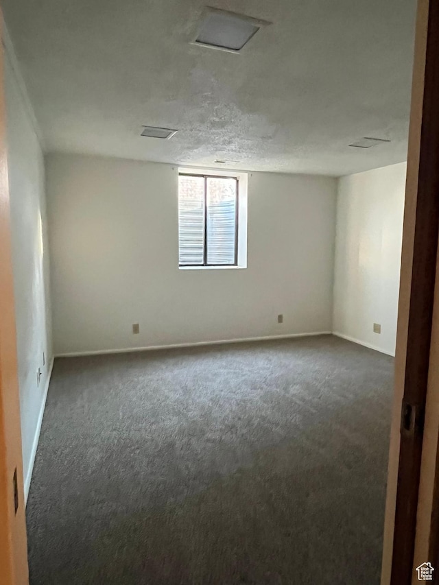 spare room with carpet and baseboards
