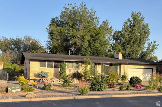 4527 S 2300 W, Roy, UT 84067 - ranch-style home with a garage, brick siding, and a chimney