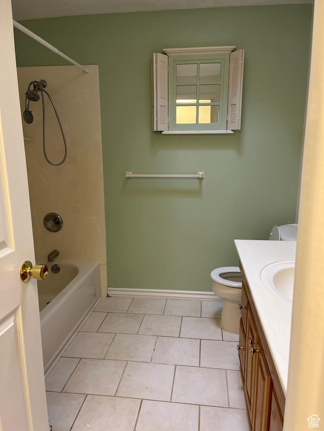 bathroom featuring shower / bathing tub combination, toilet, vanity, tile patterned flooring, and baseboards